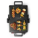 Bosch TCG3323 contact grill — opened flat with food, top view | 2000 W, 310 × 220 mm, Black — شواية بوش TCG3323 — مفتوحة مسطحة مع الأكل من أعلى | 2000 وات، 310 × 220 مم، أسود