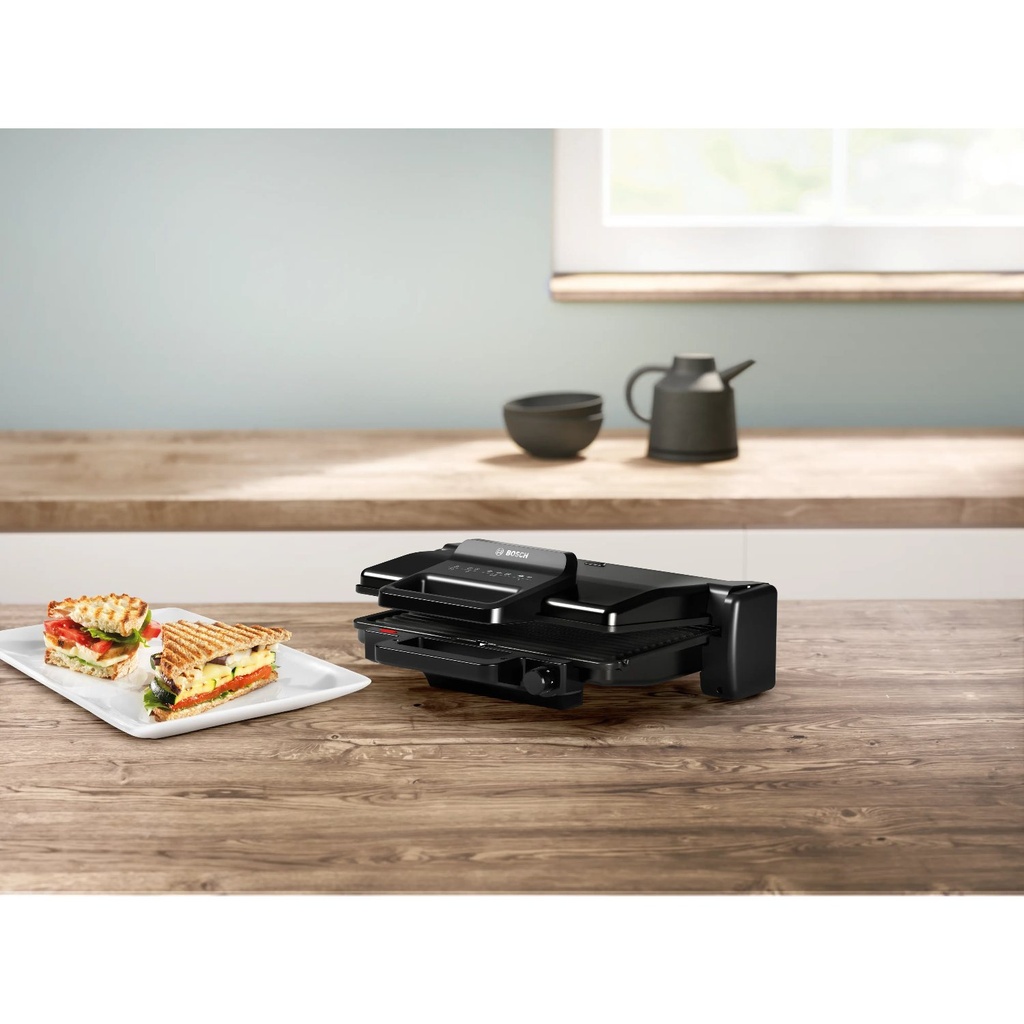 Bosch TCG3323 contact grill — grilled sandwiches on a kitchen counter | 2000 W, 310 × 220 mm, Black — شواية بوش TCG3323 — سندوتشات مشوية على مطبخ | 2000 وات، 310 × 220 مم، أسود